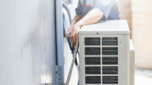 person inspecting an hvac