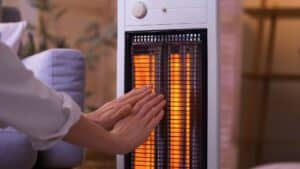 hands in front of a space heater