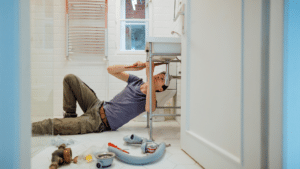 man attempting a diy plumbing repair