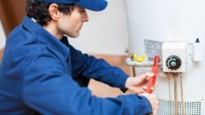 professional flushing out a water heater
